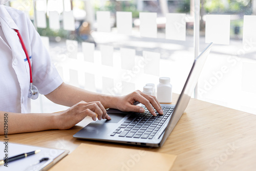 The pharmacist is entering the information of the medicines received into the computer system of a pharmacy he owns, his home pharmacy and selling basic medical supplies. Pharmacy concept.