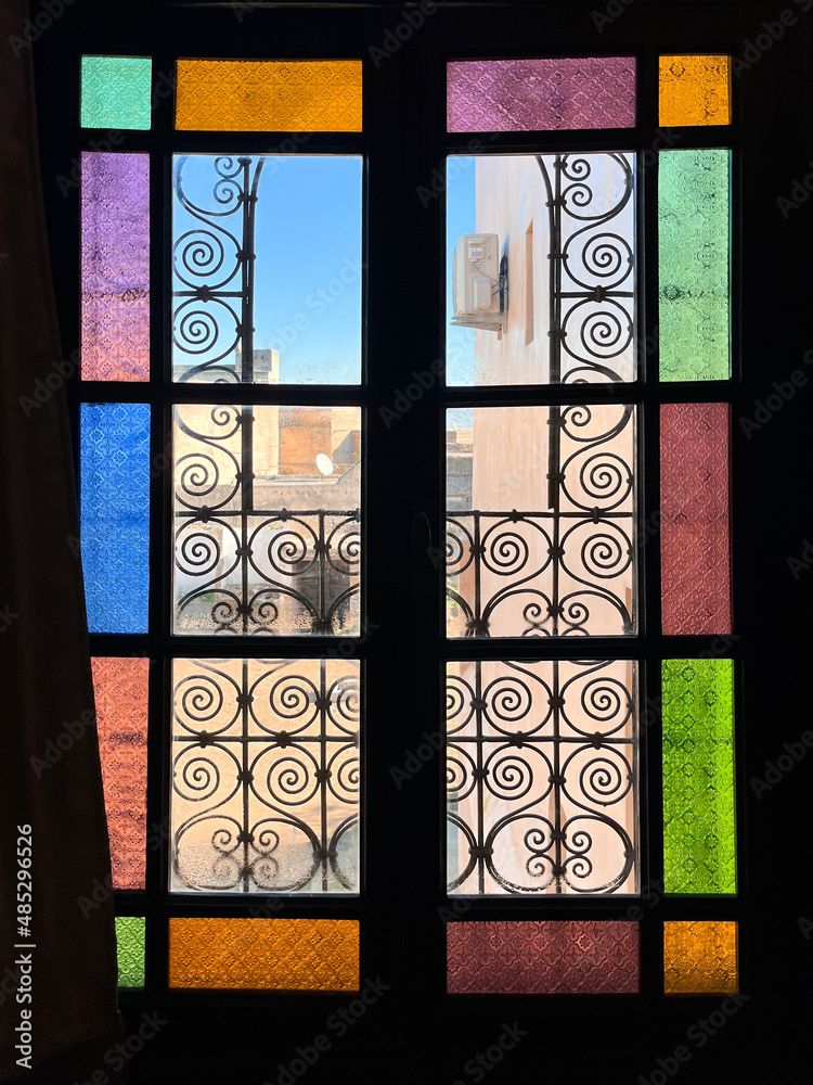 Multicolored glass window with wooden frame in a Moroccan hotel