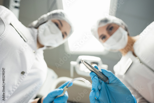 Tableau sur toile Dentist and assistant at work. Patient's point of view