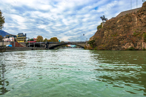 Tbilisi, Georgia. The Kura River and a view of the sculpture of King Vakhtang on a horse on a rock photo