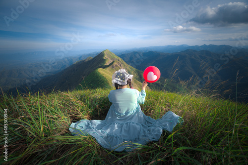 happy hiking woman on top of mountain at Khao Chang Puak, Thongphaphum National Park, Kanchanaburi Province, Thailand. Subject is blurred, noise and color effect. photo