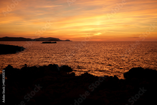 Cala Viola de Ponent, Menorca. September 2021. Magnificent sunset in the Mediterranean Sea. On one of the paradisaical beaches of the island of Menorca. © Xavi Lapuente