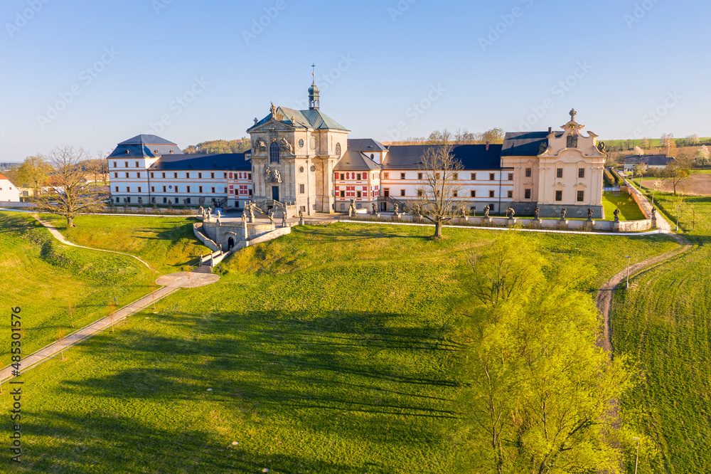 Hospital Kuks from drone in early evening sun. Spring sunlit landscape. Museum of czech pharmacy - baroque spa building.