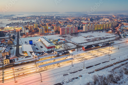 reconstructed railway station Jaromer in winter evening from above. Snowy town.