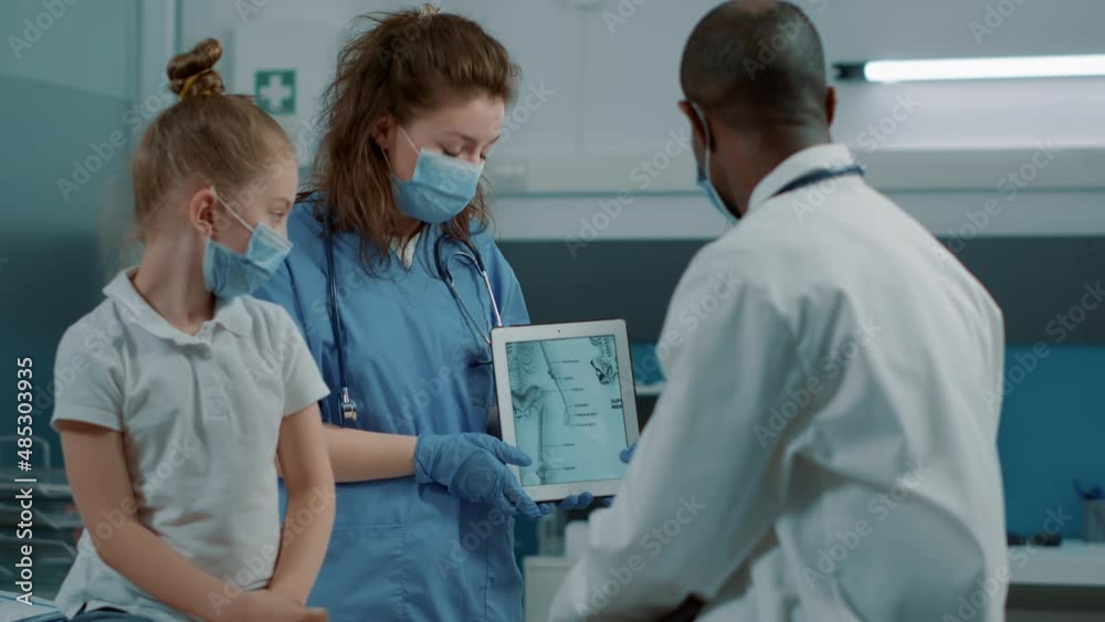 Nurse using tablet with human skeleton picture to give assistance to physician at checkup appointment. Medical worker holding osteopathy image to explain bones pain and diagnosis. Nurse using tablet with human skeleton picture to give assistance to physician at checkup appointment. Medical worker holding osteopathy image to explain bones pain and diagnosis.