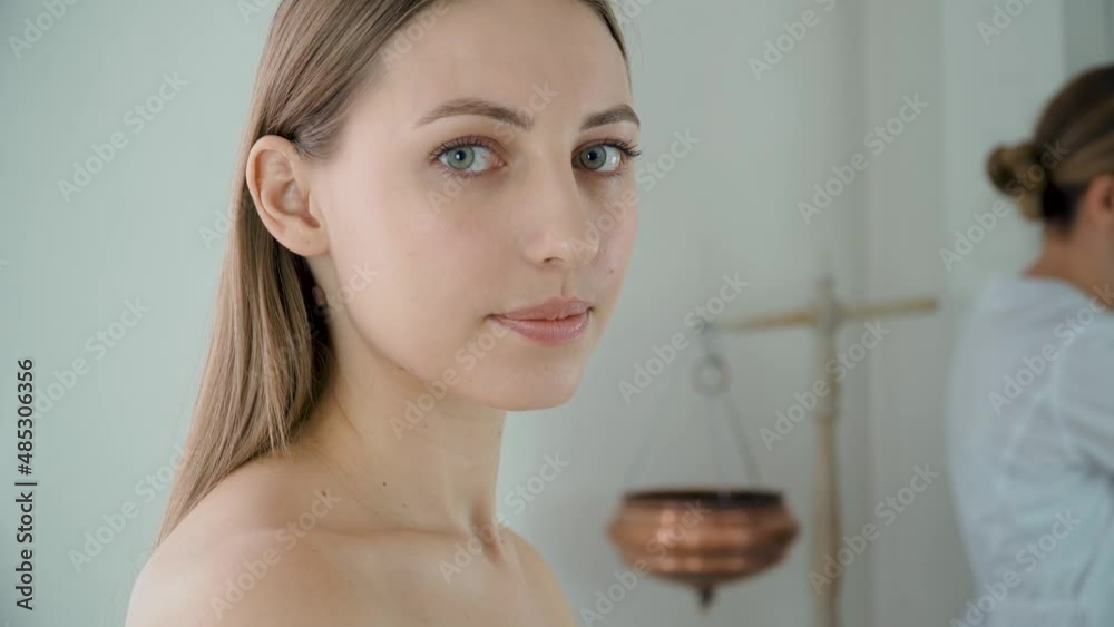 Portrait young woman in spa salon before beauty procedure. Concept of body care and alternative medicine Portrait young woman in spa salon before beauty procedure. Concept of body care and alternative medicine