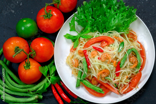 Thai papaya salad, Thai traditional Thai papaya salad Cooked with papaya, tomatoes, green beans and peanuts. Spicy Thai food concept.