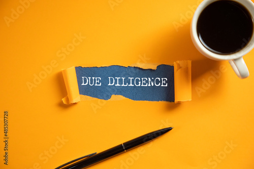 Photos due diligence text on torn paper