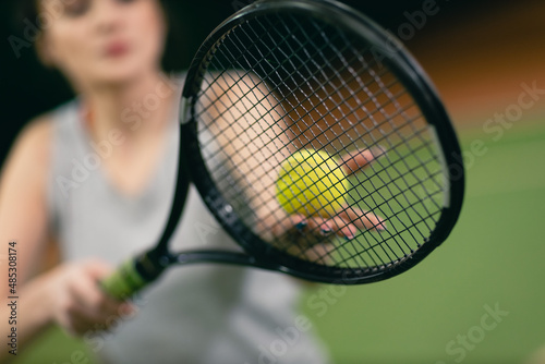 Tennis woman player playing training with racket and ball at court. © primipil