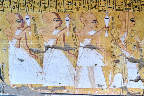A colorful mural from the tomb Inkherkhau (TT359) on the West Bank of Nile - Thebes, Luxor, Egypt, depicting a funerary procession with priests performing libations, the first wearing leopard skin photo