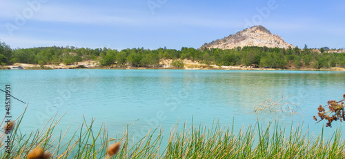 Natural scene including trees, lakes and sand and rocks with many colors
