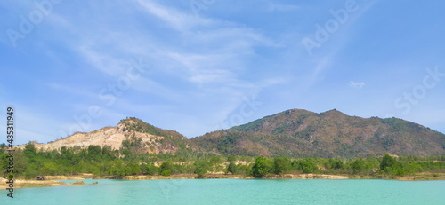Natural scene including trees, lakes and sand and rocks with many colors