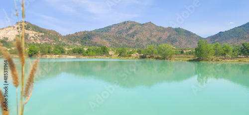 Natural scene including trees, lakes and sand and rocks with many colors