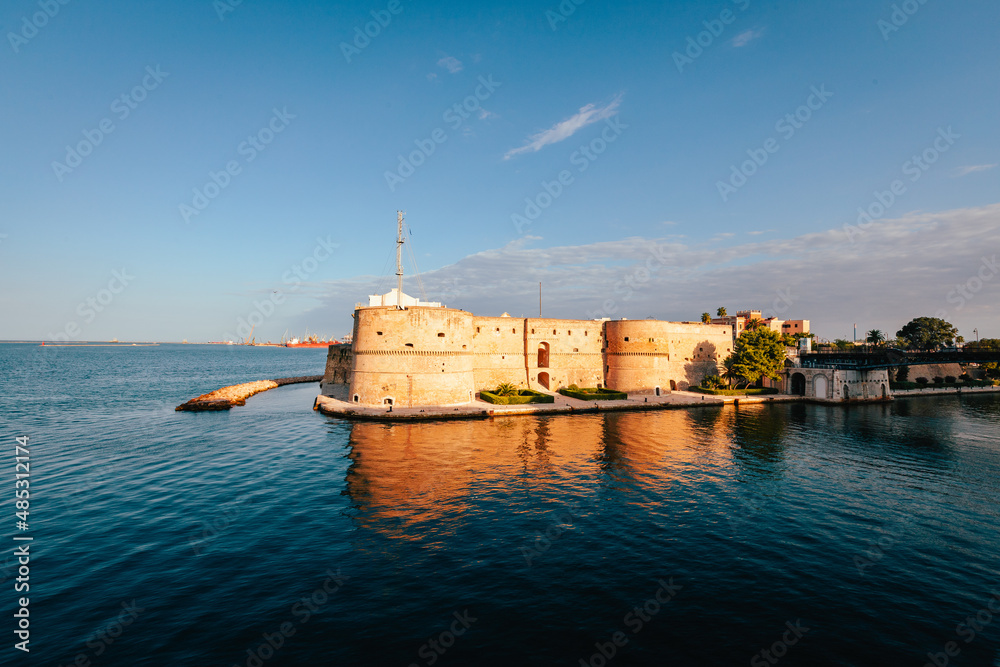 Castle by the sea, blue sky with clouds, Aragonese castle in Taranto