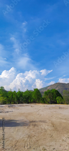 Natural scene including trees, lakes and sand and rocks with many colors