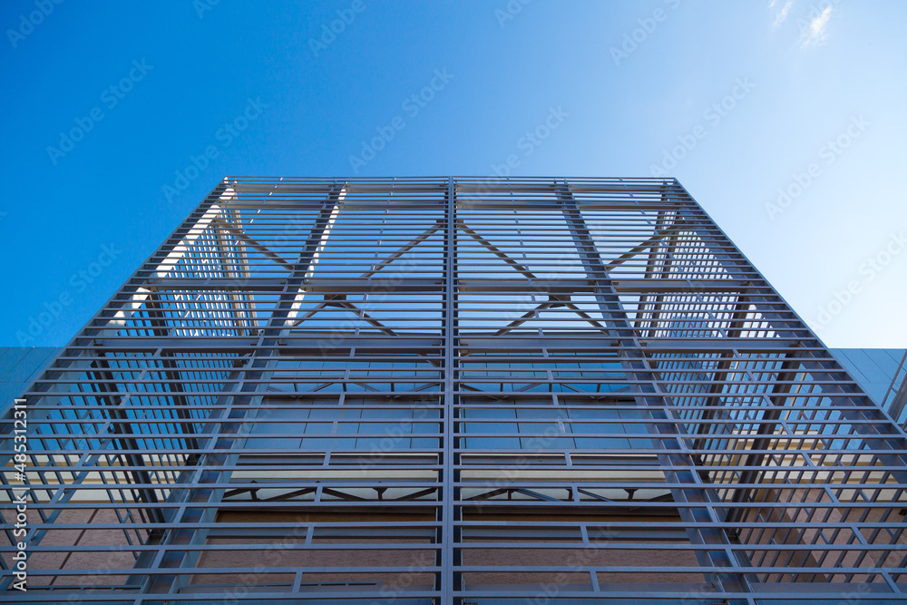 The exterior interior of the building in the form of a metal contruction against a blue sky background.