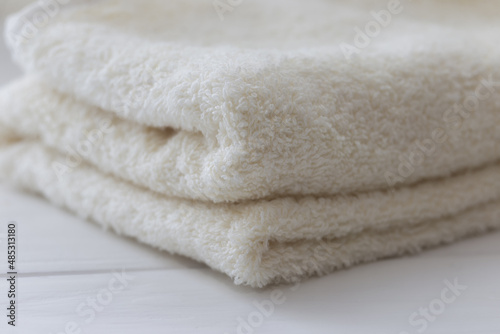 White fluffy bath towels on the white background 