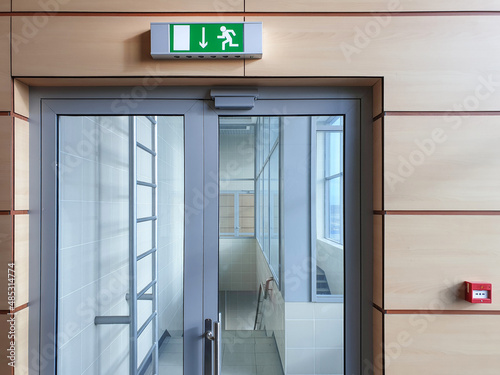 Emergency exit with glass door in airport office building Fototapet