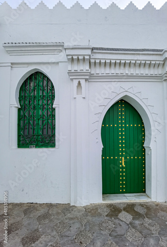 Green wooden window and door in the old medina of Asilah © Mounir