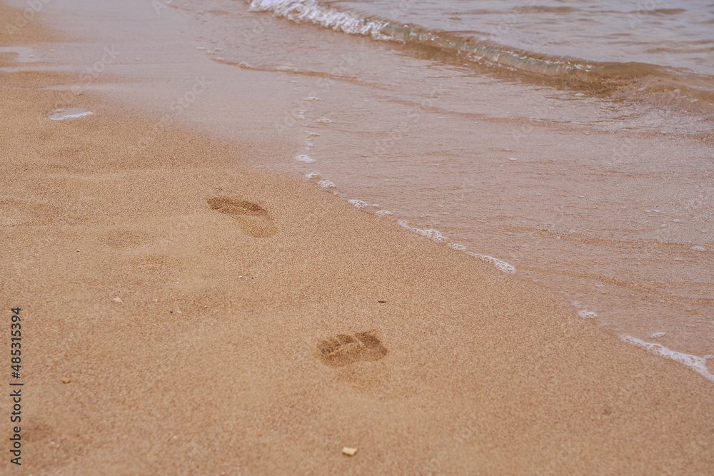 Footprints of a man on the sand on the beach. Footprints of a man on the sand on the beach.