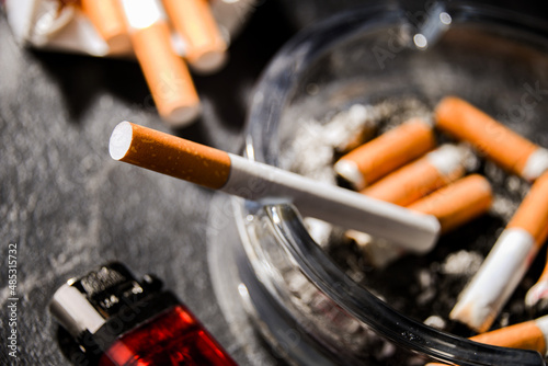 Fotografie Composition with an ashtray and cigarettes