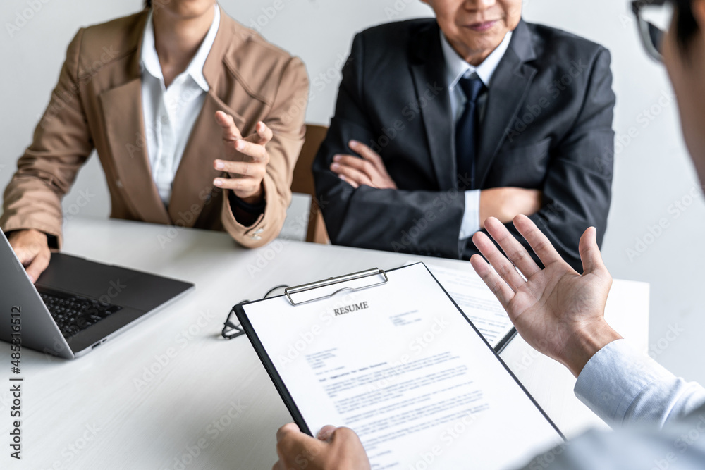 Business man explaining about his profile to two selection committee manager sitting in during job Interview, interview the job and hiring Business man explaining about his profile to two selection committee manager sitting in during job Interview, interview the job and hiring