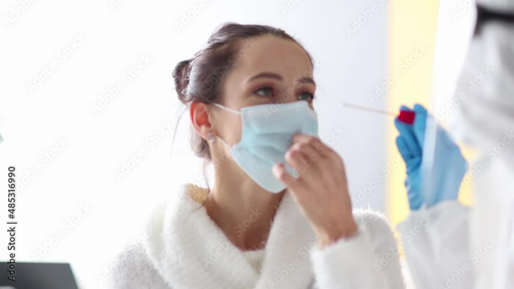 Doctor taking sample of PCR test for coronovirus from woman closeup Doctor taking sample of PCR test for coronovirus from woman closeup