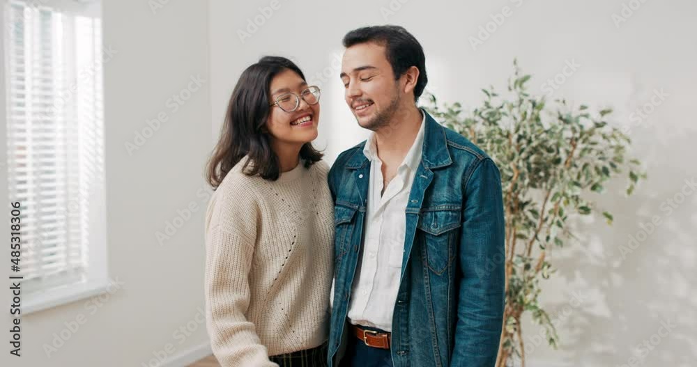 Young couple in love renting buying their first apartment together joyful smiling woman embraces boyfriend in hand holding keys to flat they stand in the middle of a newly renovated empty room Young couple in love renting buying their first apartment together joyful smiling woman embraces boyfriend in hand holding keys to flat they stand in the middle of a newly renovated empty room