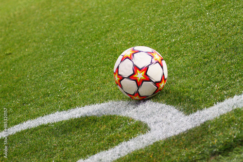A soccer ball sits on the pitch near by corner area