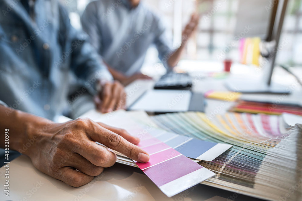 Young colleagues designers working together on a creative project and ...