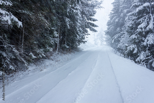Quiet countryside road during snow storm in Filzmoos, Austria