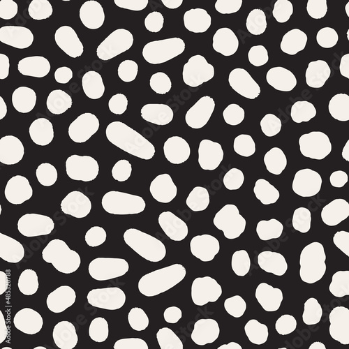 Irregular polka dot seamless repeat pattern. Random placed, vector spots all over surface print on black background.