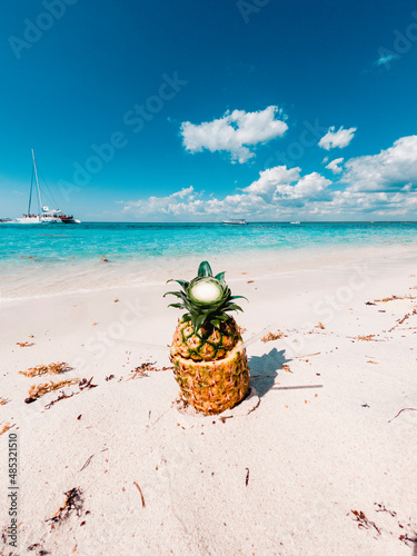 Tasty PIna Colada coktail served in pineapple in beautiful tropical beach in Catalina Island, Domincan Republic. photo