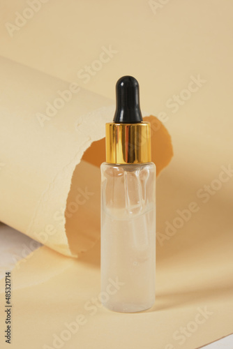 Dropper Bottle with clipping path on a beige background