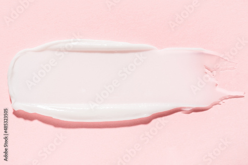Smudge of organic antiaging cream professional skincare cosmetic product for home and salon usage on pink close upper view