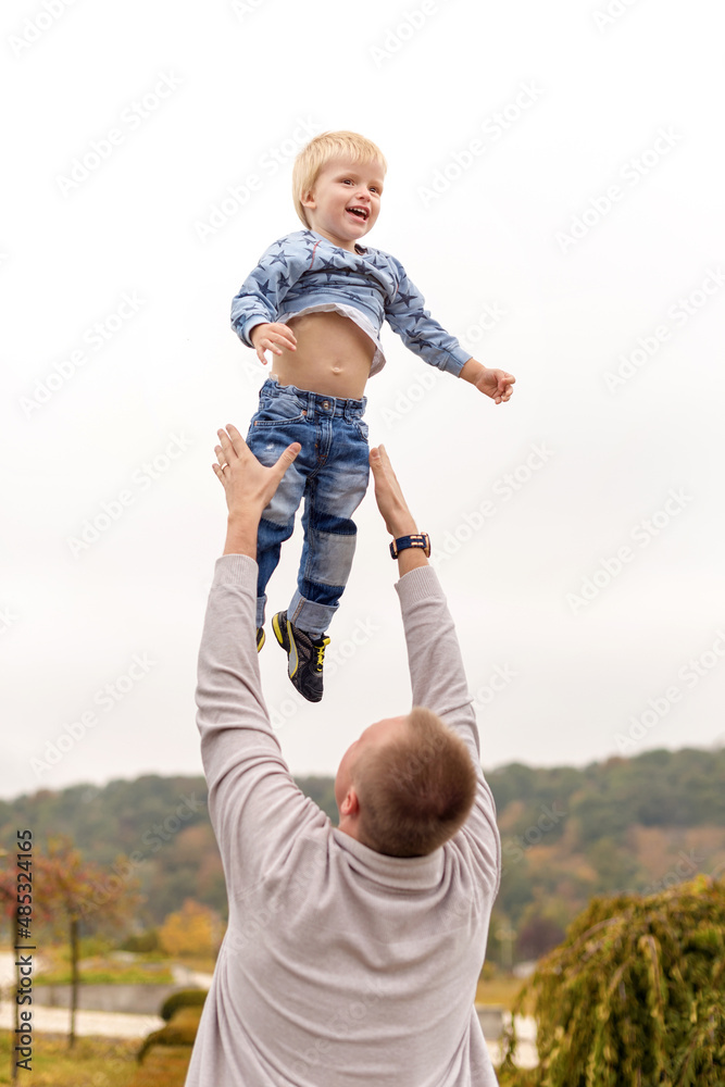 Happy joyful father having fun throws up in the air child. Family, travel, vacation, father's day concept. Happy joyful father having fun throws up in the air child. Family, travel, vacation, father's day concept.