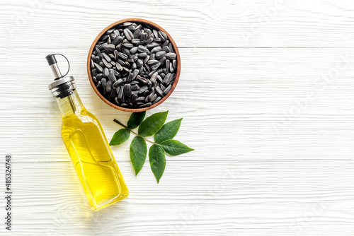 Sunflower cooking oil in bottle with ingredient - sunflower seeds