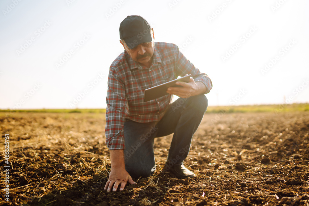 Farmer with tablet in the field. Agriculture, gardening or ecology concept. Smart farm. Farmer with tablet in the field. Agriculture, gardening or ecology concept. Smart farm.