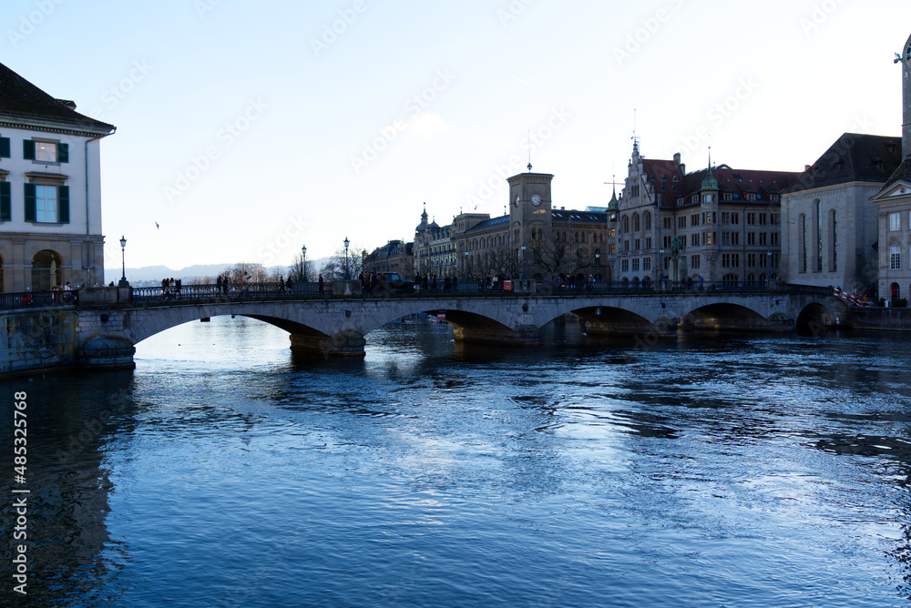 Famous Minster Bridge at the old town of Zürich in backlight on a sunny winter day. Photo taken February 5th, 2022, Zurich, Switzerland.