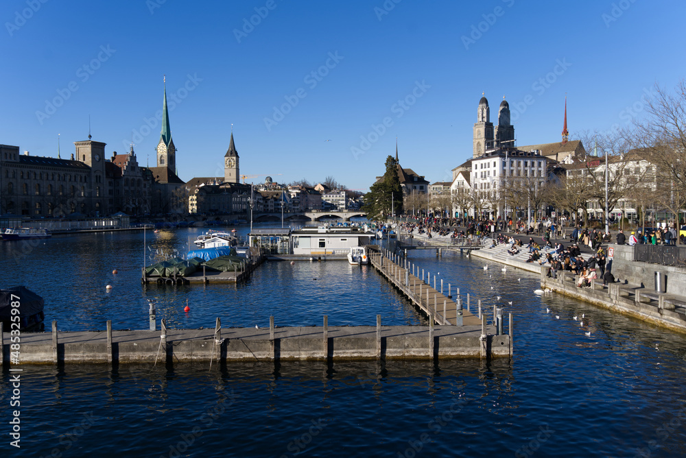 Skyline of the old town of Zürich on a sunny winter afternoon with river Limmat in the foreground. Photo taken February 5th, 2022, Zurich, Switzerland.