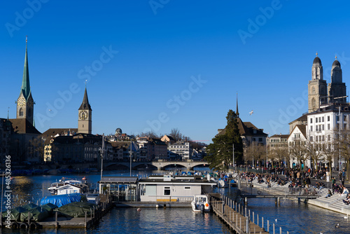 Skyline of the old town of Zürich on a sunny winter afternoon with river Limmat in the foreground. Photo taken February 5th, 2022, Zurich, Switzerland.