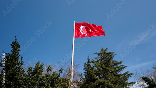 Turkish Flag. Flag of Turkey waving on blue sky in the forest. Noise included. Turkish national days 4k background video. photo