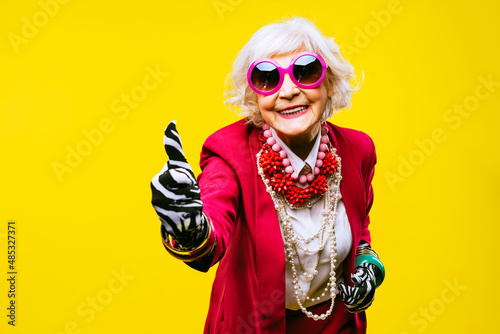 Cool and stylish senior old woman with fashionable clothes photo