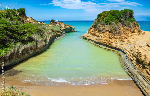 Canal D'Amour or Channel of Love in Sidari, Corfu island in Greece. Famous romantic beach with clay rocky cliffs and rugged coast. Popular destination for summer vacation photo