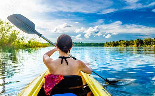Woman with kayak on the Amazon river, Brazil