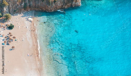Fototapeta Naklejka Na Ścianę i Meble -  Spectacular view of the clear beach and transparent turquoise sea of Butterfly Valley. Butterfly Valley (Turkish: Kelebekler Vadisi) is a valley in Fethiye district of Mugla Province, Turkey.