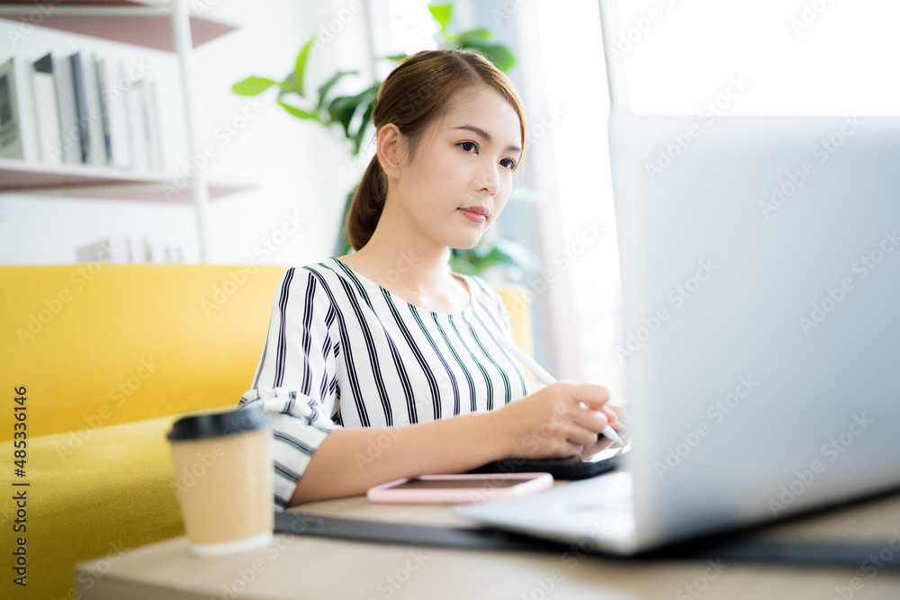 A photo of a bright Asian business woman working at home in the room. The idea is Work form Home Finance Marketing Bright Portrait Simple A photo of a bright Asian business woman working at home in the room. The idea is Work form Home Finance Marketing Bright Portrait Simple