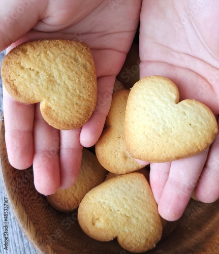 homemade cookies hearts in children's hands. breakfast for a child