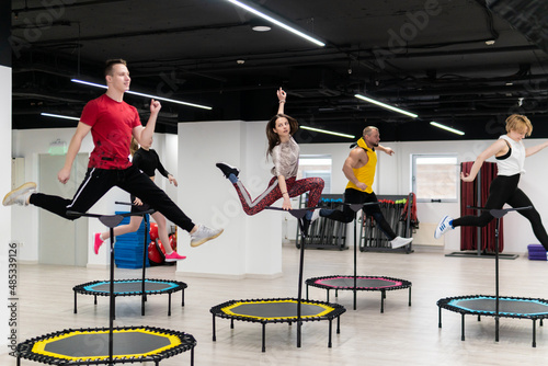 Women's and men's group on a sports trampoline, fitness training, healthy life - a concept trampoline group batut instructor men, In the afternoon fit athletic in training from exercise shaping