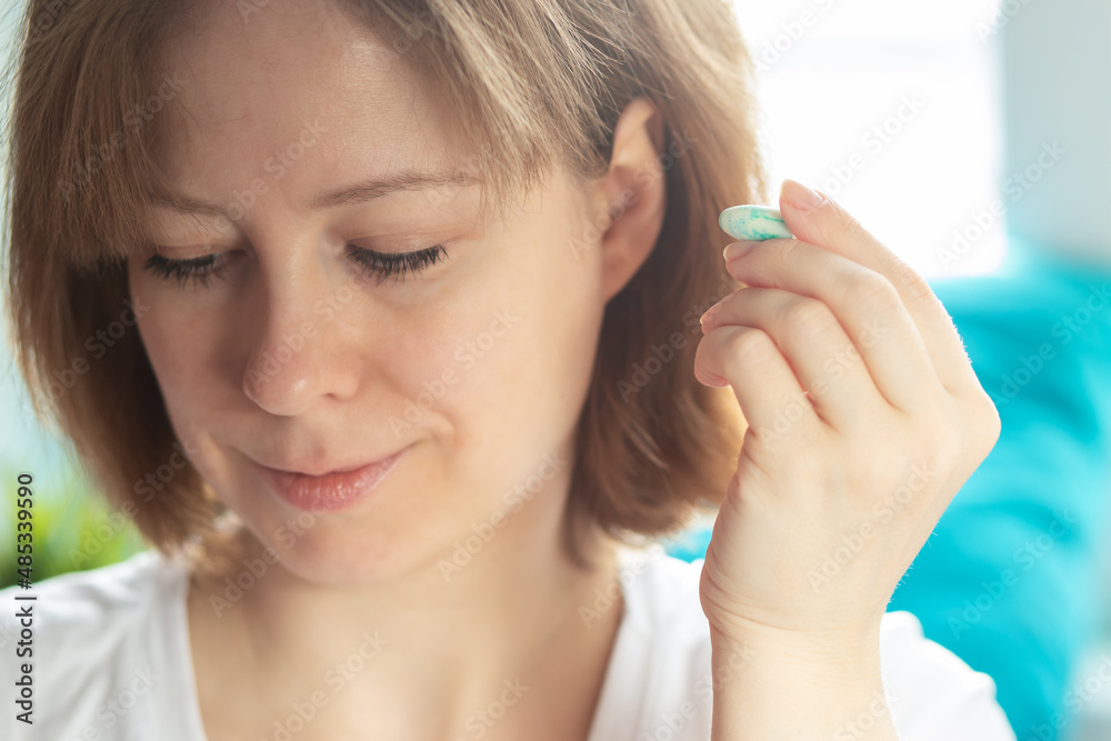 sleep insert, woman with earplugs in the morning after a restful sleep sleep insert, woman with earplugs in the morning after a restful sleep